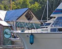 Genoa Bay Marina store over the bow of the 'Velkommen'